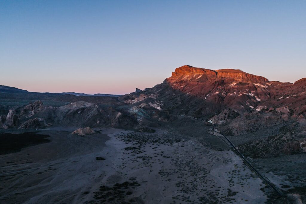 A stunning aerial view of a mountain landscape at sunset, showcasing natural beauty.